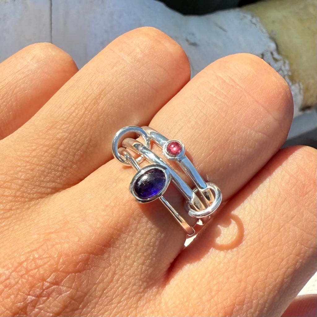 Silver ring with gemstones on a hand
