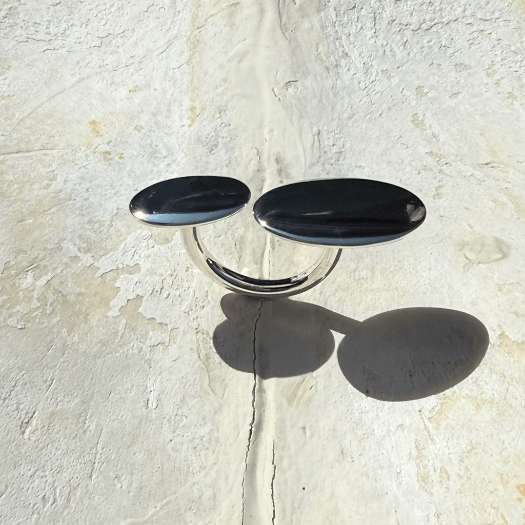 Large pebble silver ring on rock stone surface