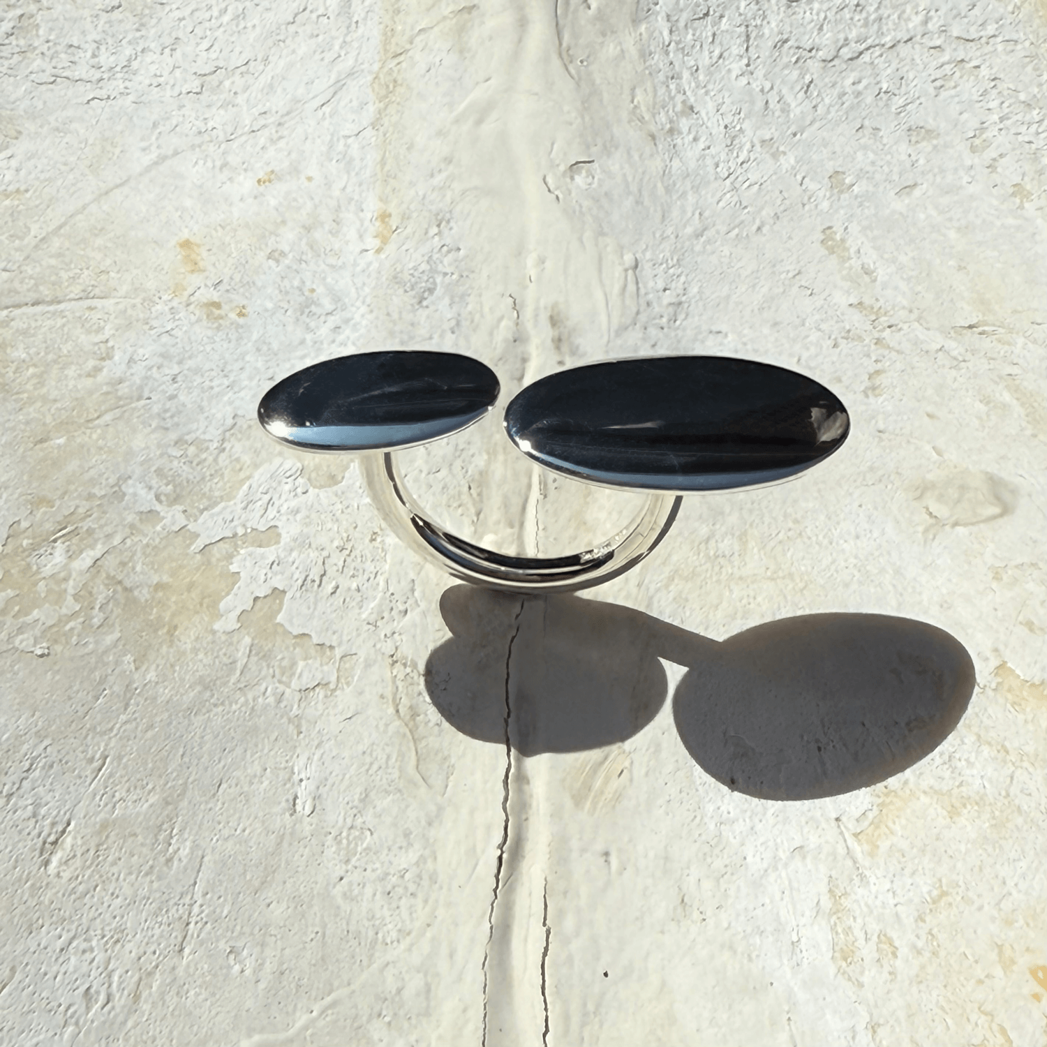 Large pebble silver ring on rock stone surface