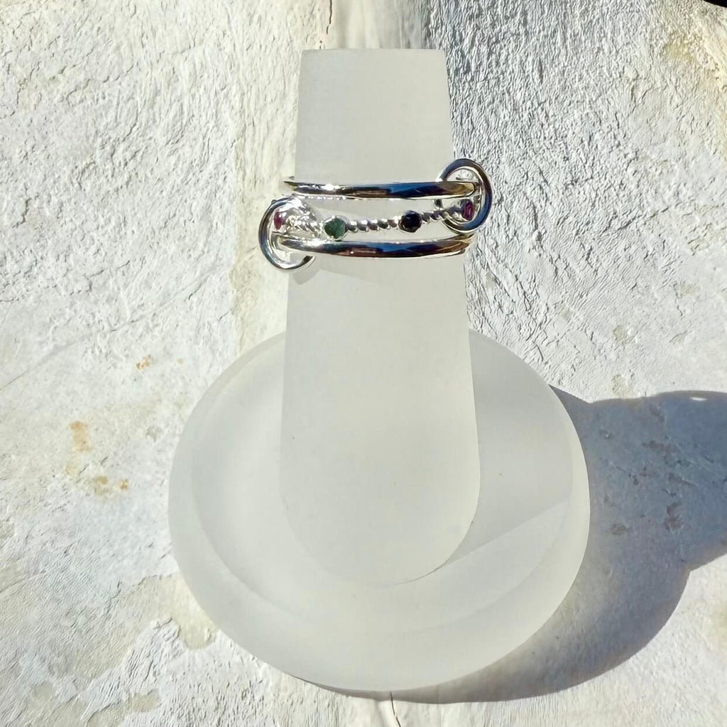 Frosted light bulb with a silver ring on a textured white background