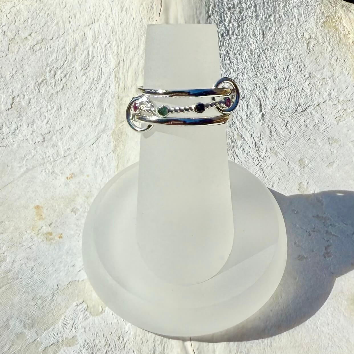 Frosted light bulb with a silver ring on a textured white background