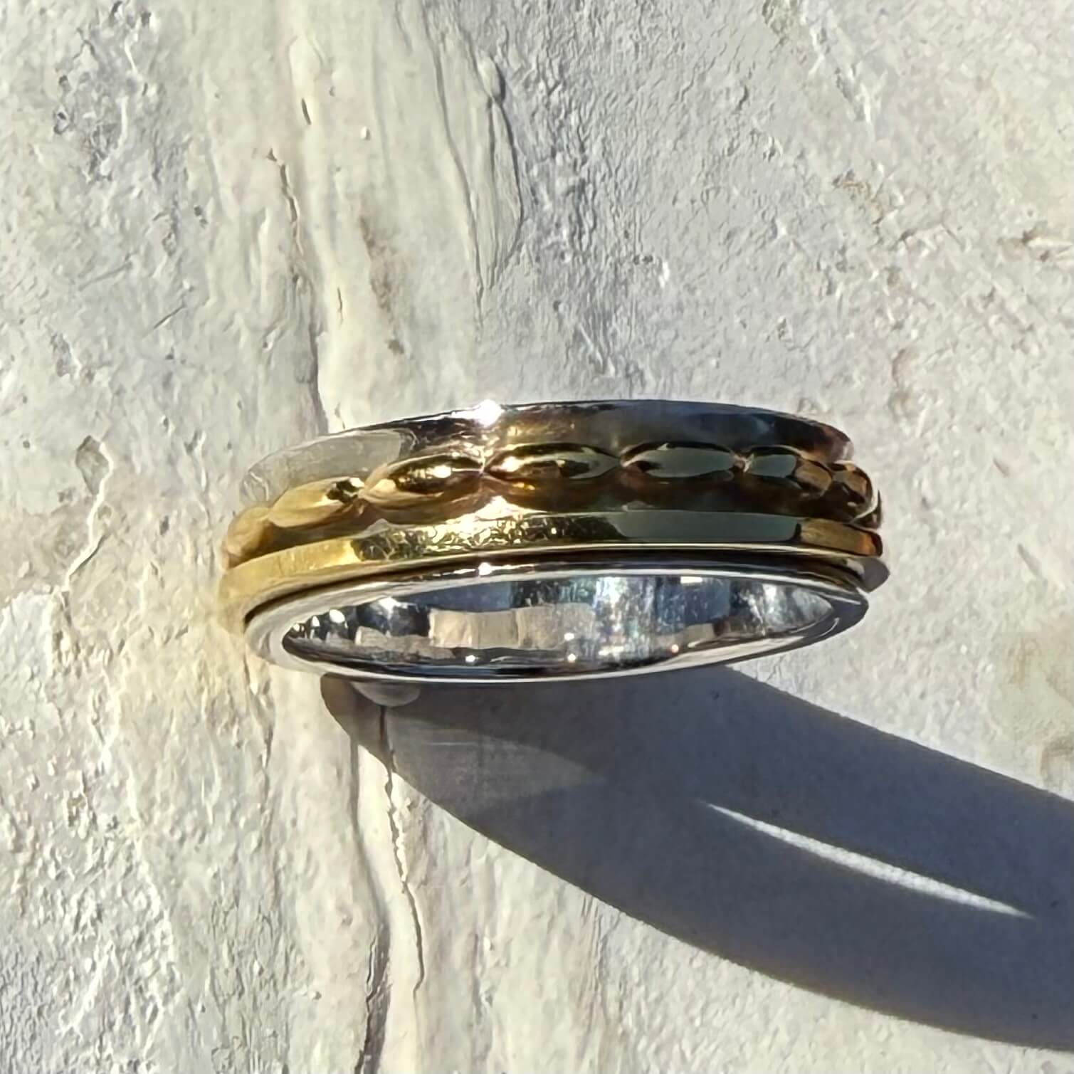 Gold and silver ring on a textured white surface