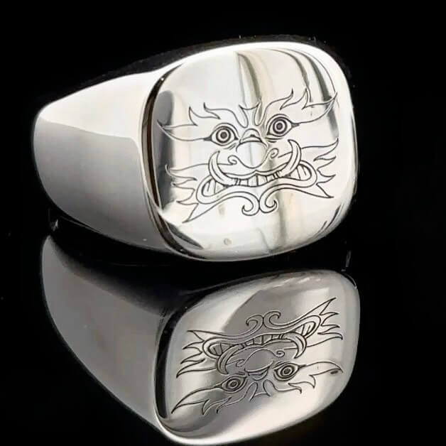 Square Yak Signer silver ring on a black background